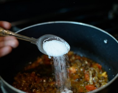 adding salt to stew